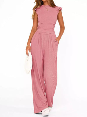 Pink maternity two-piece ensemble with ruffled cap sleeves and wide-leg pants.