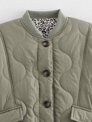 Moss quilted button-down jacket with leopard print lining and ribbed collar.