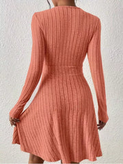 Burnt Coral ribbed texture wrap mini dress with long sleeves and A-line skirt.