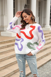White crewneck sweater with abstract swirl pattern in red, purple, pink, and green.