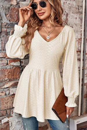Ivory textured empire waist blouse with shirred sleeves and V-neck