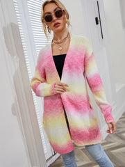 Longline knit cardigan in rainbow gradient pink, yellow, and white with pockets.