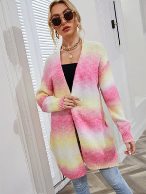 Longline knit cardigan in rainbow gradient pink, yellow, and white with pockets.