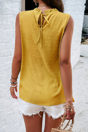 Yellow textured yoke dot tank top with ruffled neckline and tie back detail.