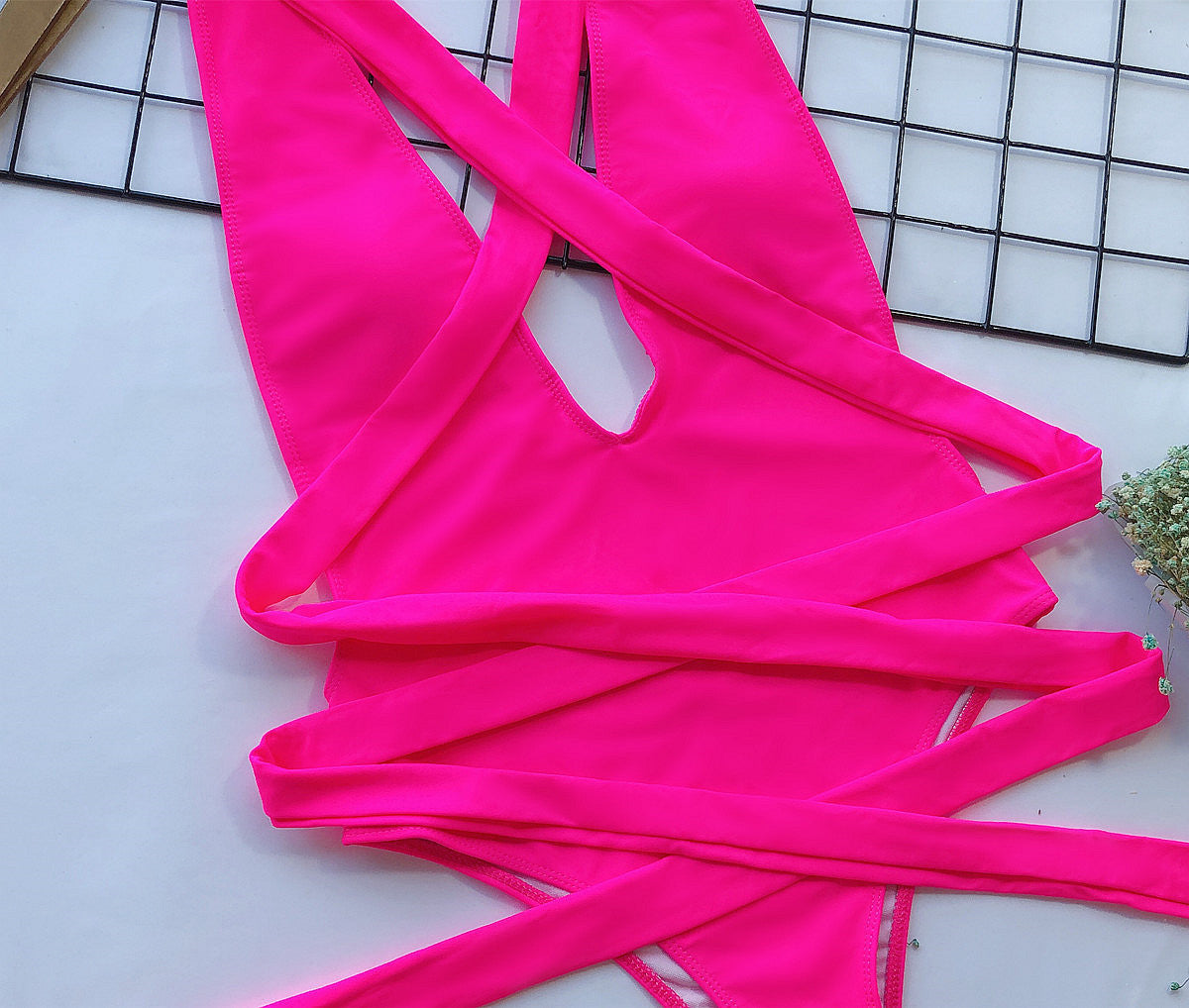 Hot pink wrap-around halterneck plunge swimsuit with crisscross ties