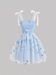 Blue floral embroidered mini dress with tie shoulder straps and a tulle overlay.