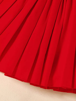 Red toddler outfit skirt with pleats and a ruffled hem.