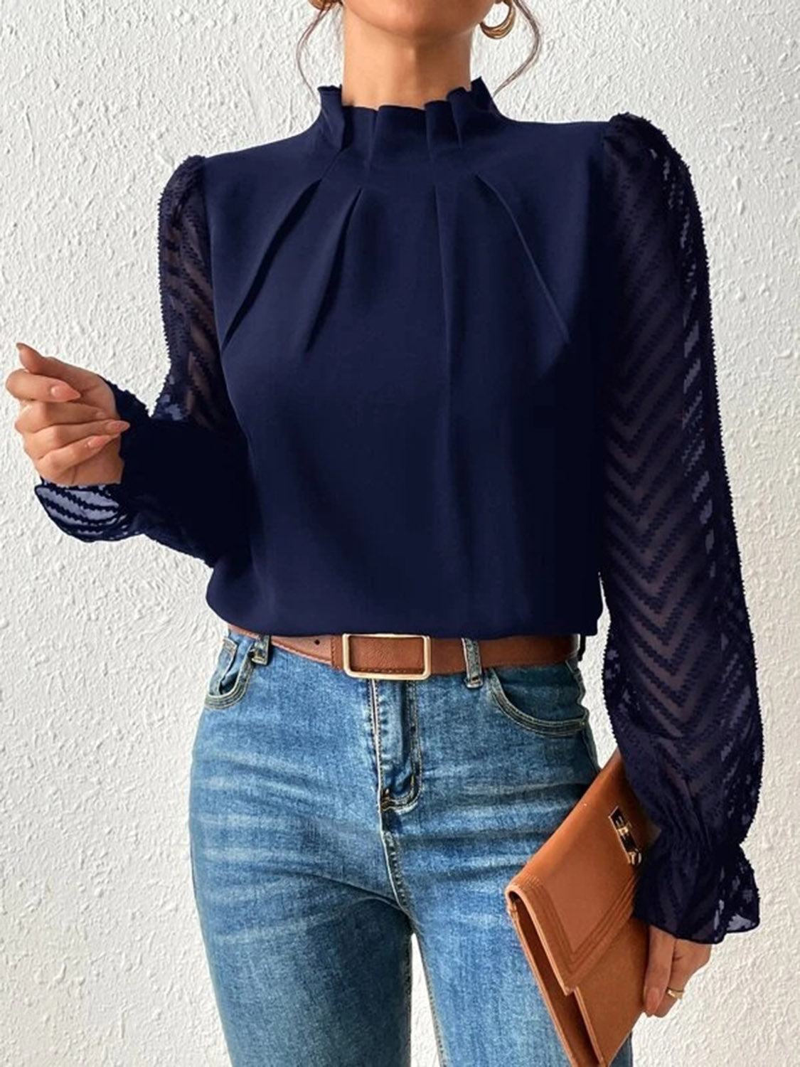 Navy chevron sleeve ruffle neck blouse with pleated front and sheer sleeves.