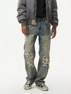Distressed blue denim wide leg jeans with plaid patches, men's vintage style.