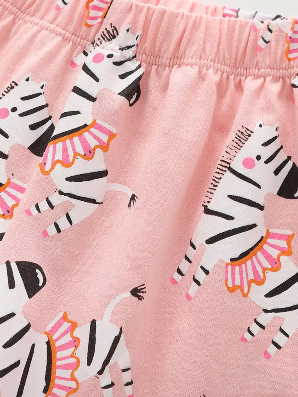 Pink cotton blend toddler shorts with a playful zebra print and elastic waistband.