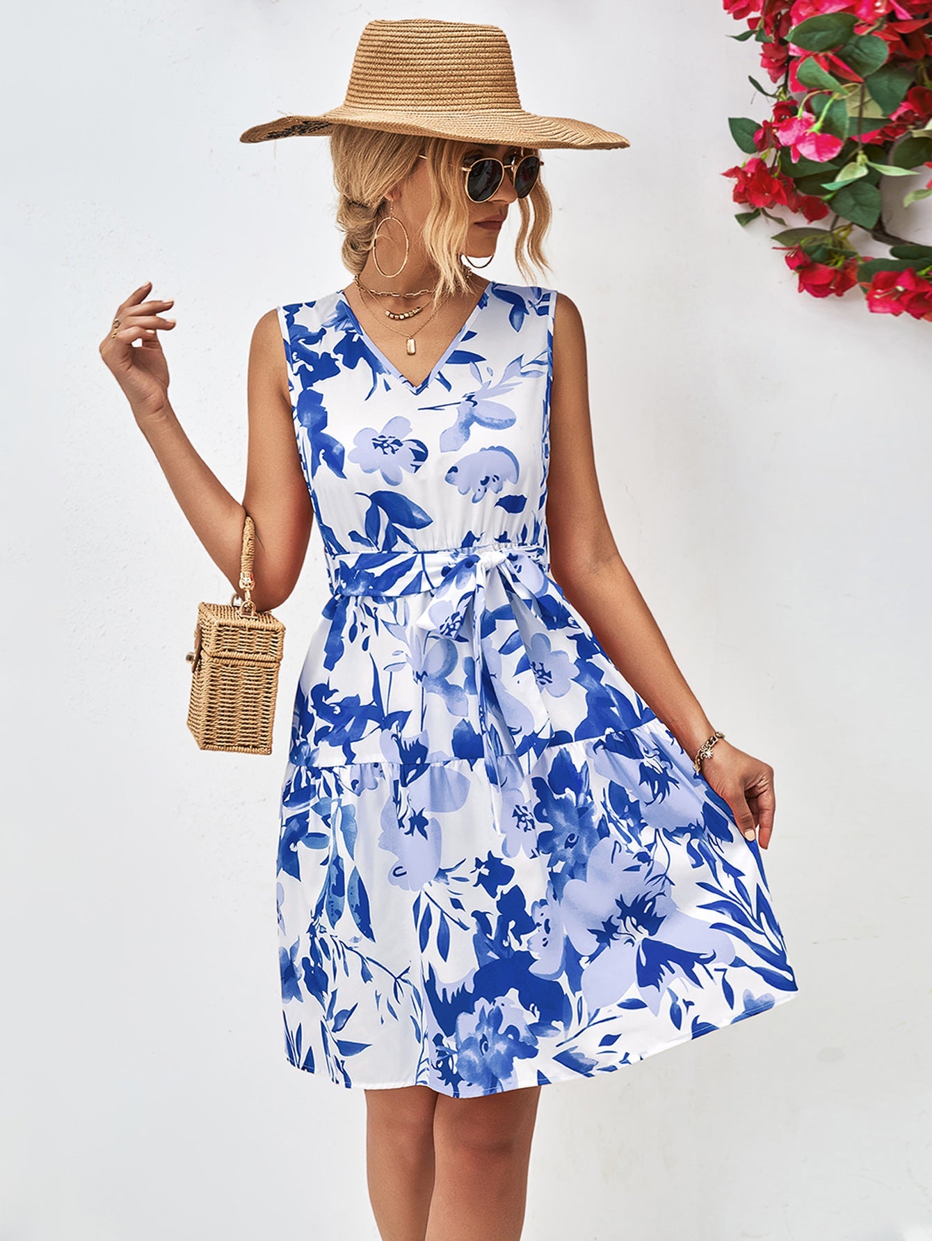 Blue watercolor floral tiered mini dress with V-neck and belted waist.