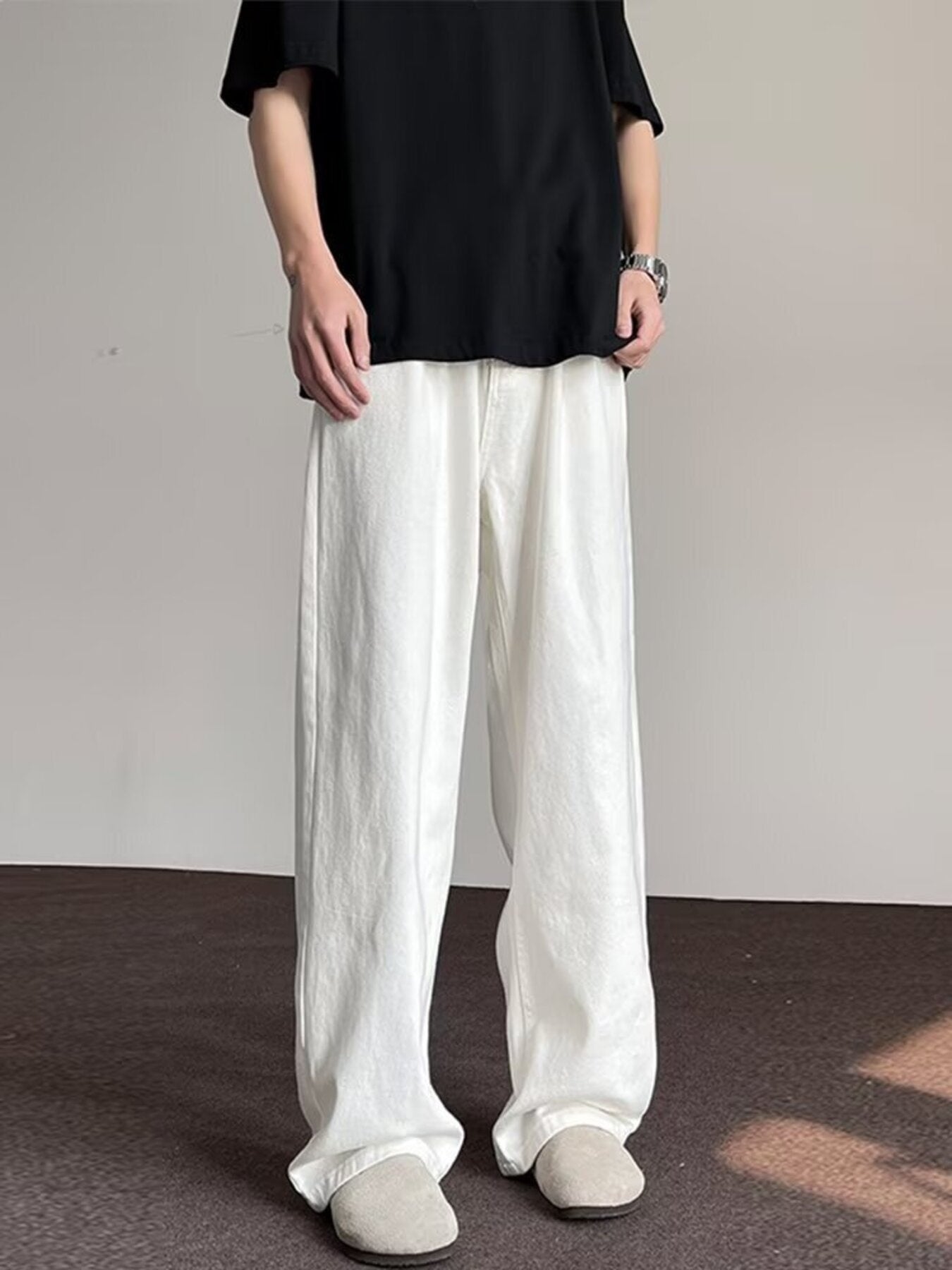 Men's white wide-leg jeans with a relaxed fit and casual style.