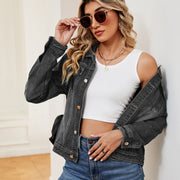Faded wash dark denim trucker jacket with button front and chest pockets.
