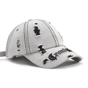 Distressed baseball cap with embroidered text and frayed details.