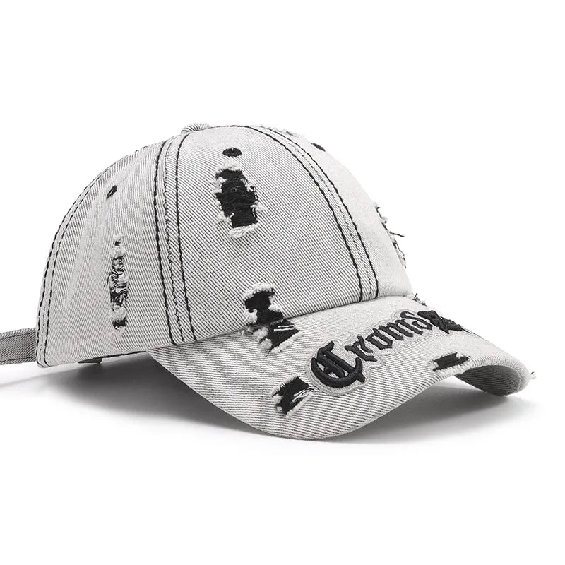 Distressed baseball cap with embroidered text and frayed details.