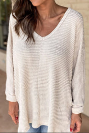 Beige waffle knit v-neck long sleeve top with slit hem detail