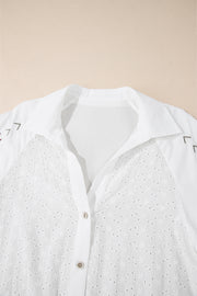 White eyelet blouse with embroidered detail and poet sleeves.