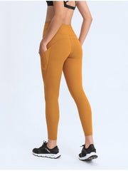 Sculpt leggings in Tangerine with side pockets and a high waist.