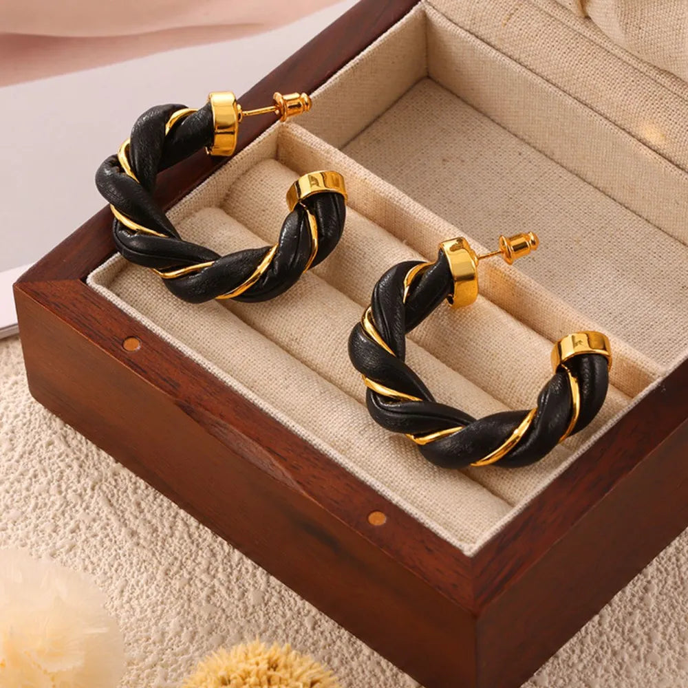 Black braided leather and gold hoop earrings with twisted detail