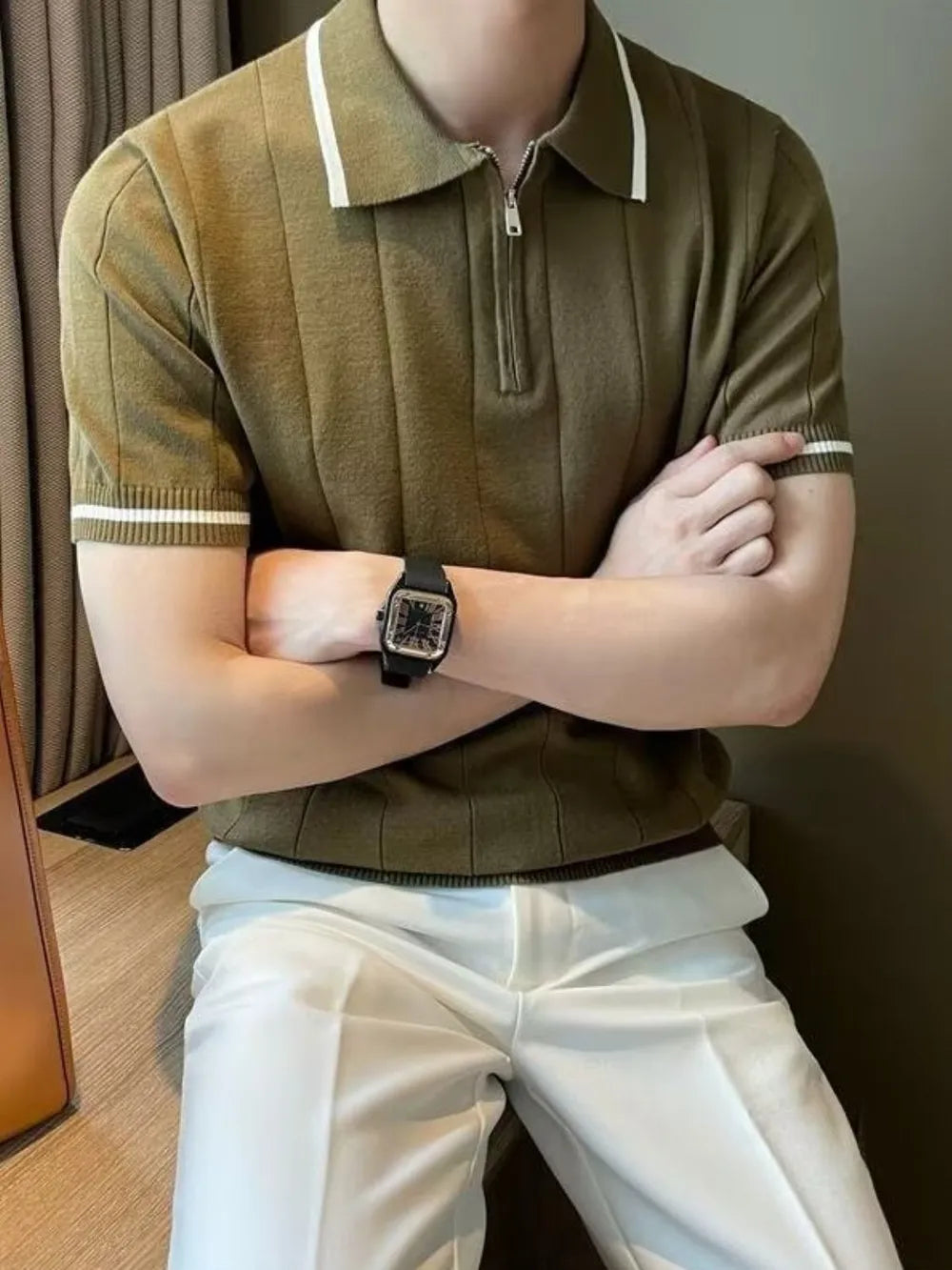 Olive ribbed knit polo shirt with contrast trim on collar and sleeves.