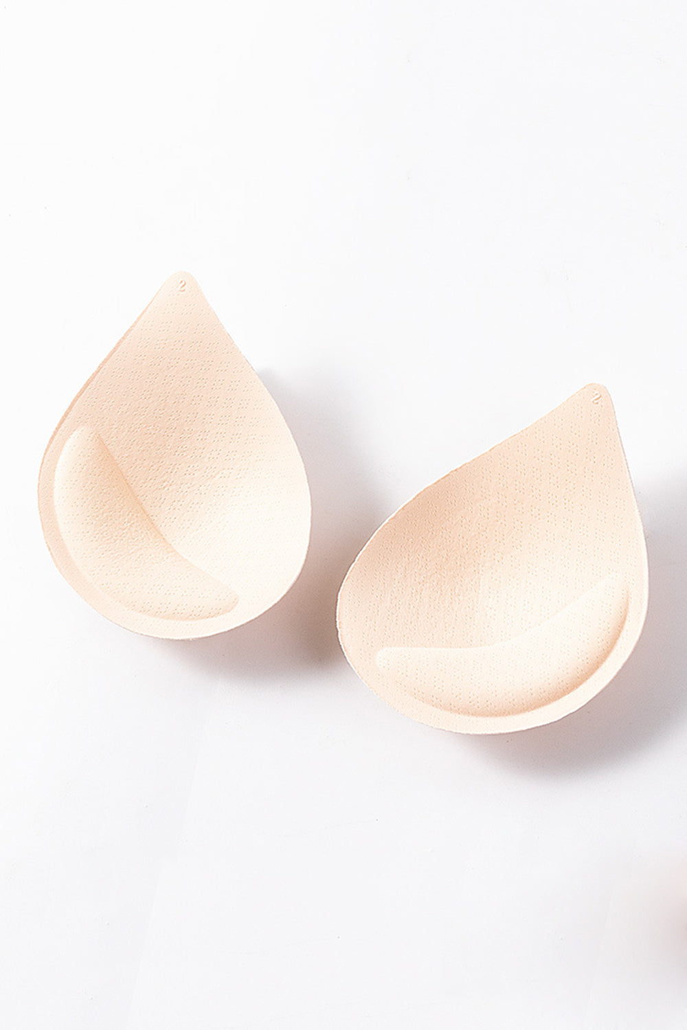 Apricot teardrop bra inserts with textured surface