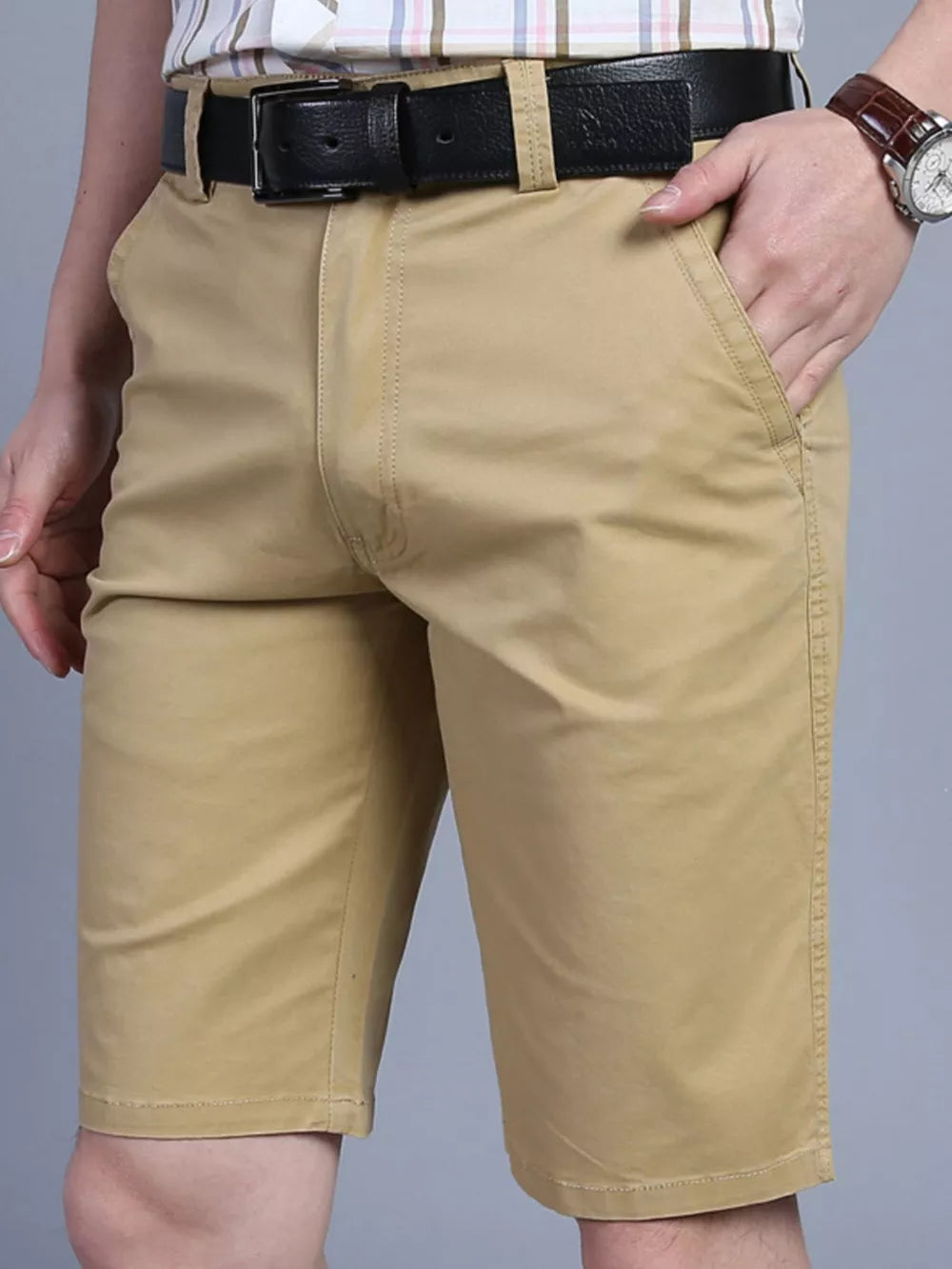 Khaki chino shorts for men with pockets and a black belt.