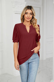 Wine perforated puff sleeve keyhole blouse with a v-neckline.