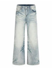 Men's light blue vintage wash wide leg jeans with distressed details.