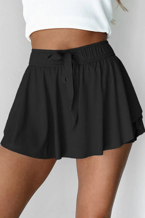 Black flared skort with tie waist and elastic waistband.