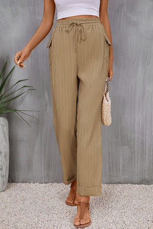 Khaki textured drawstring waistline trousers with cuffed hems and cargo pockets.