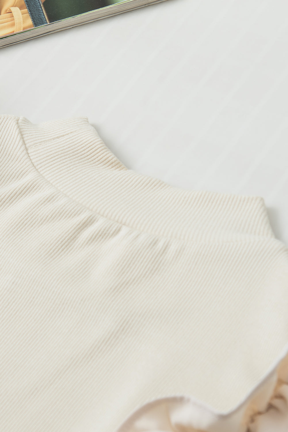 Beige ribbed mock neck top with ruffled sleeves