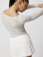 White floral lace long sleeve blouse with scalloped neckline and lettuce hem detail.
