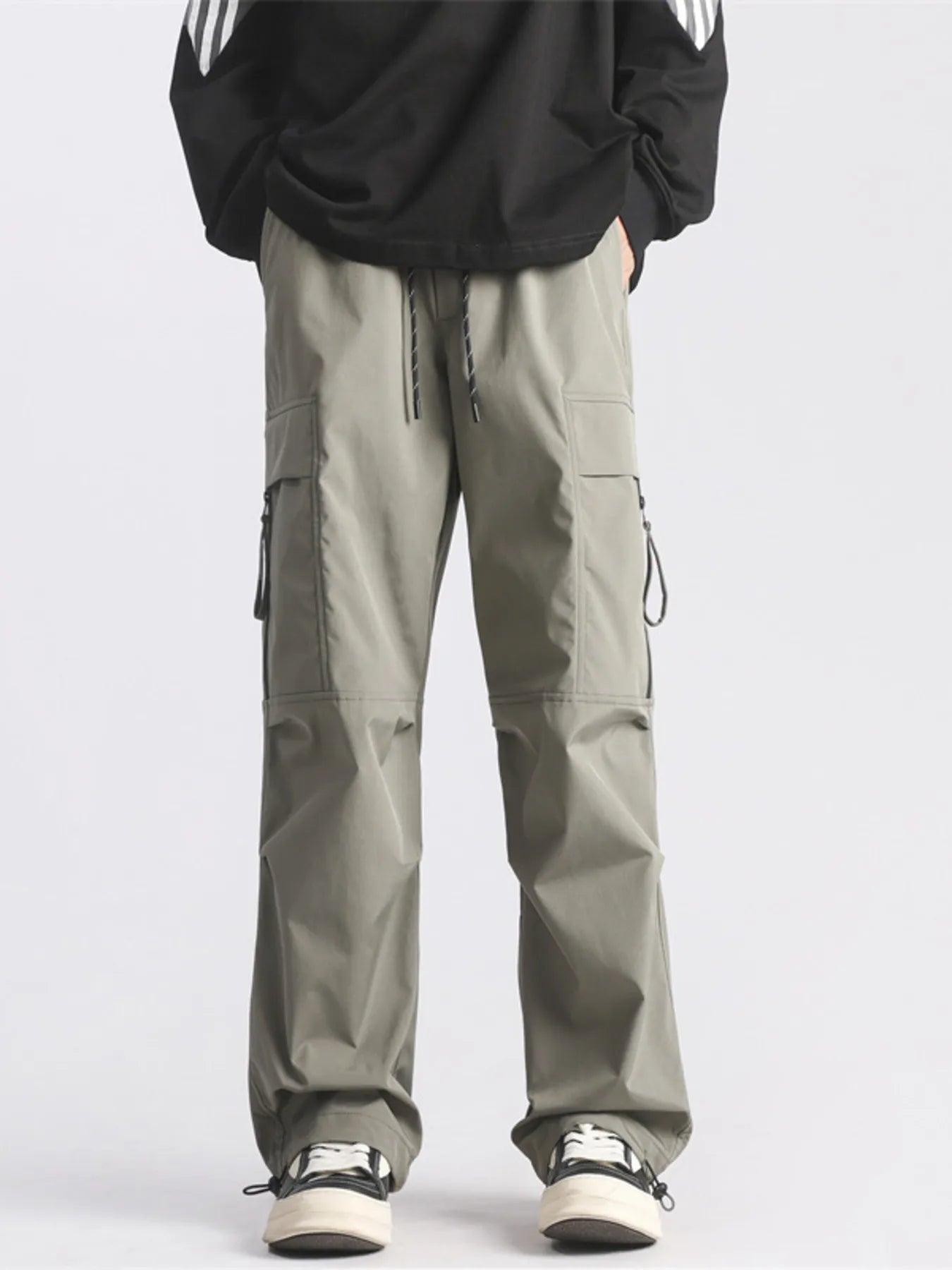 Plus-size loose fit cargo pants in green with drawstring waist and multiple pockets.