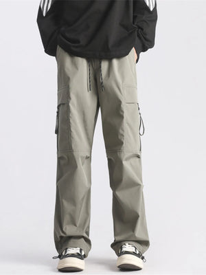Plus-size loose fit cargo pants in green with drawstring waist and multiple pockets.