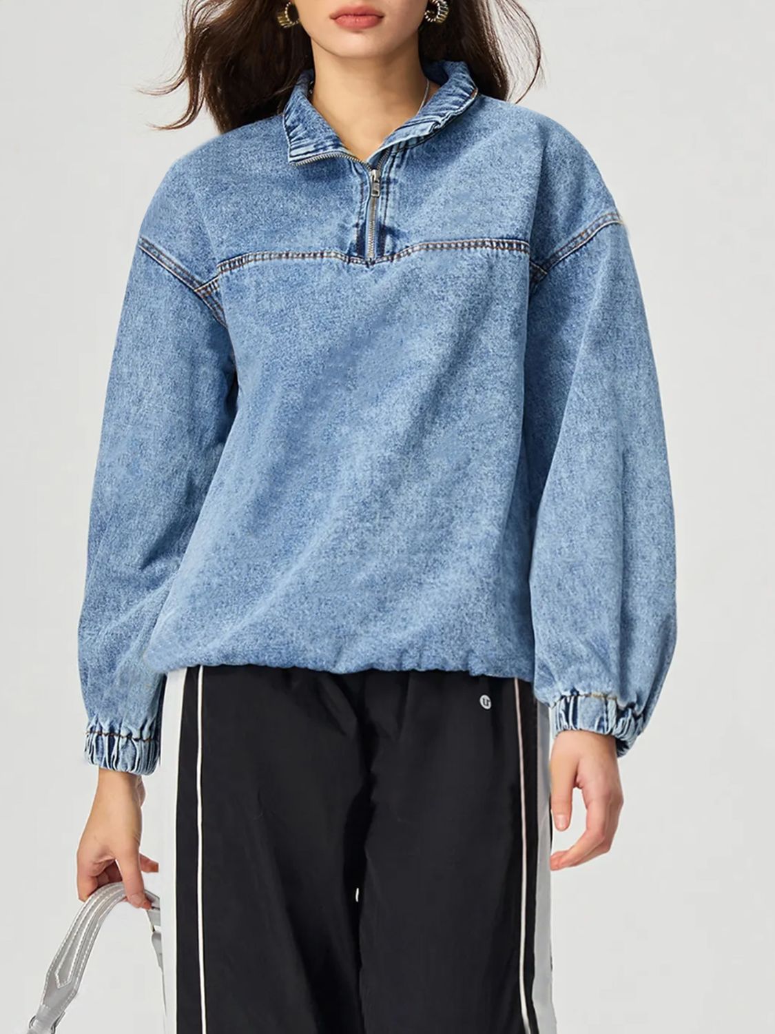 Acid wash denim pullover with quarter zip and elastic cuffs.