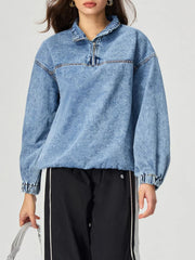 Acid wash denim pullover with quarter zip and elastic cuffs.