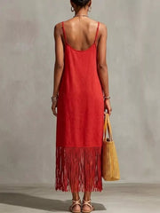 Red maxi dress with spaghetti straps and fringe hem detail.