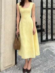 Sleeveless yellow a-line midi dress with square neckline and subtle seams.
