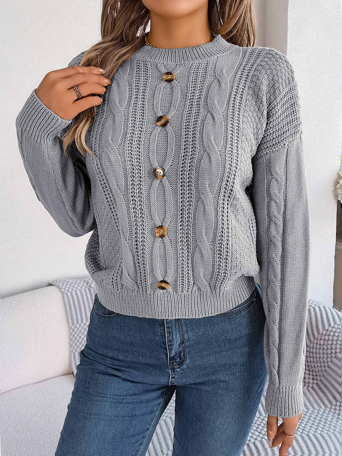 Chic button-up sweater in charcoal cable knit with a mock neck and button details.