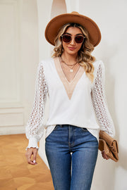 White knit v-neck blouse with lace sleeves and textured neckline detail.