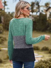 Blouson top with colorblock design in green, gray, and black, long sleeves, and crew neck.