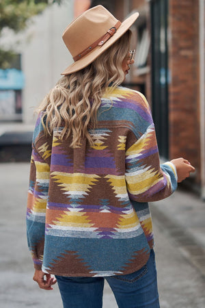 Southwestern print overshirt jacket in multi-color with buttoned front, styled with jeans and a hat.