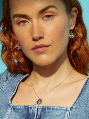 Silver celestial medallion zircon pendant necklace with matching earrings.