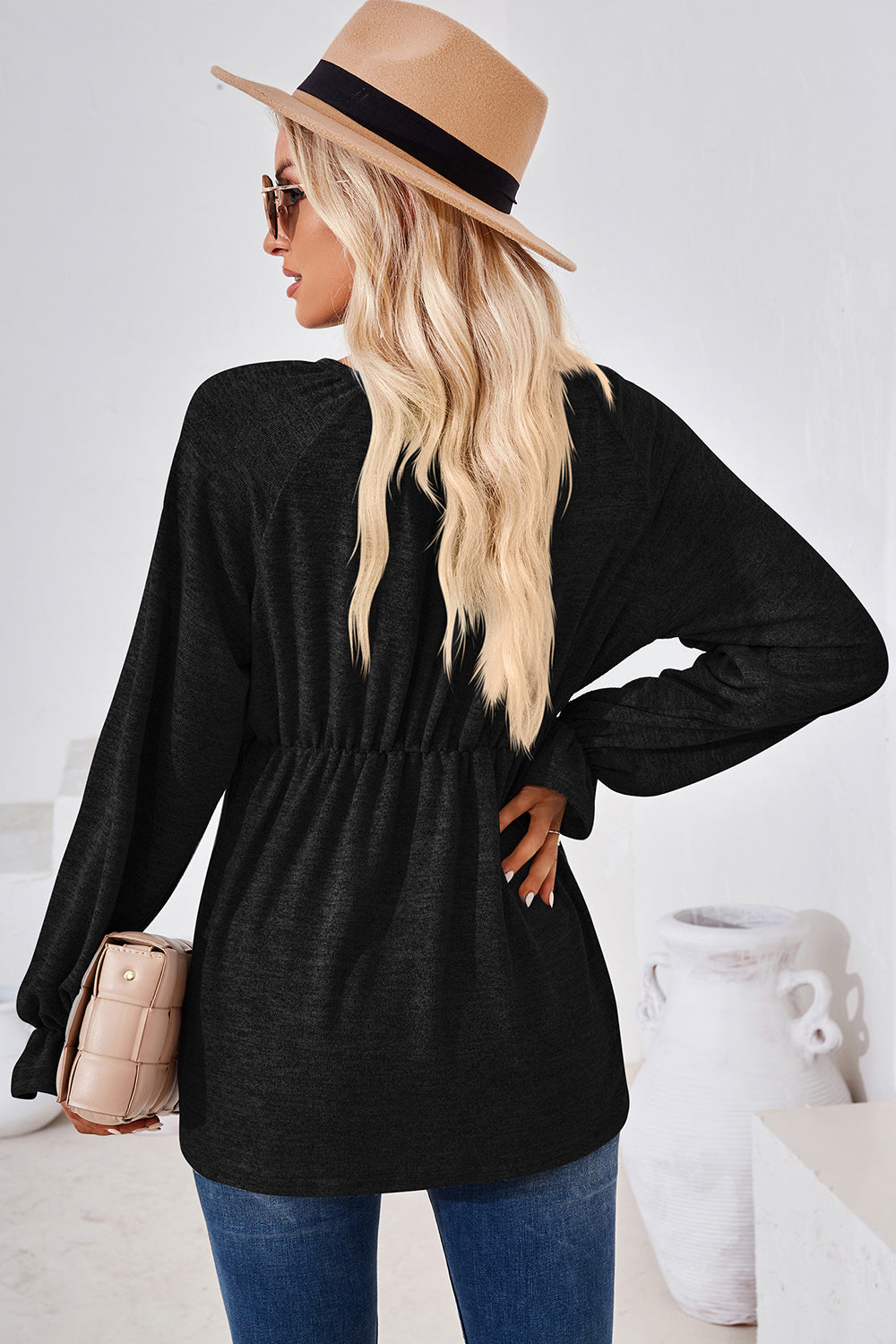 Black long sleeve blouse with cinched waist and balloon sleeves.