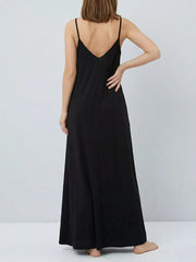 Black maxi dress with spaghetti straps and V-neck, flowing skirt.