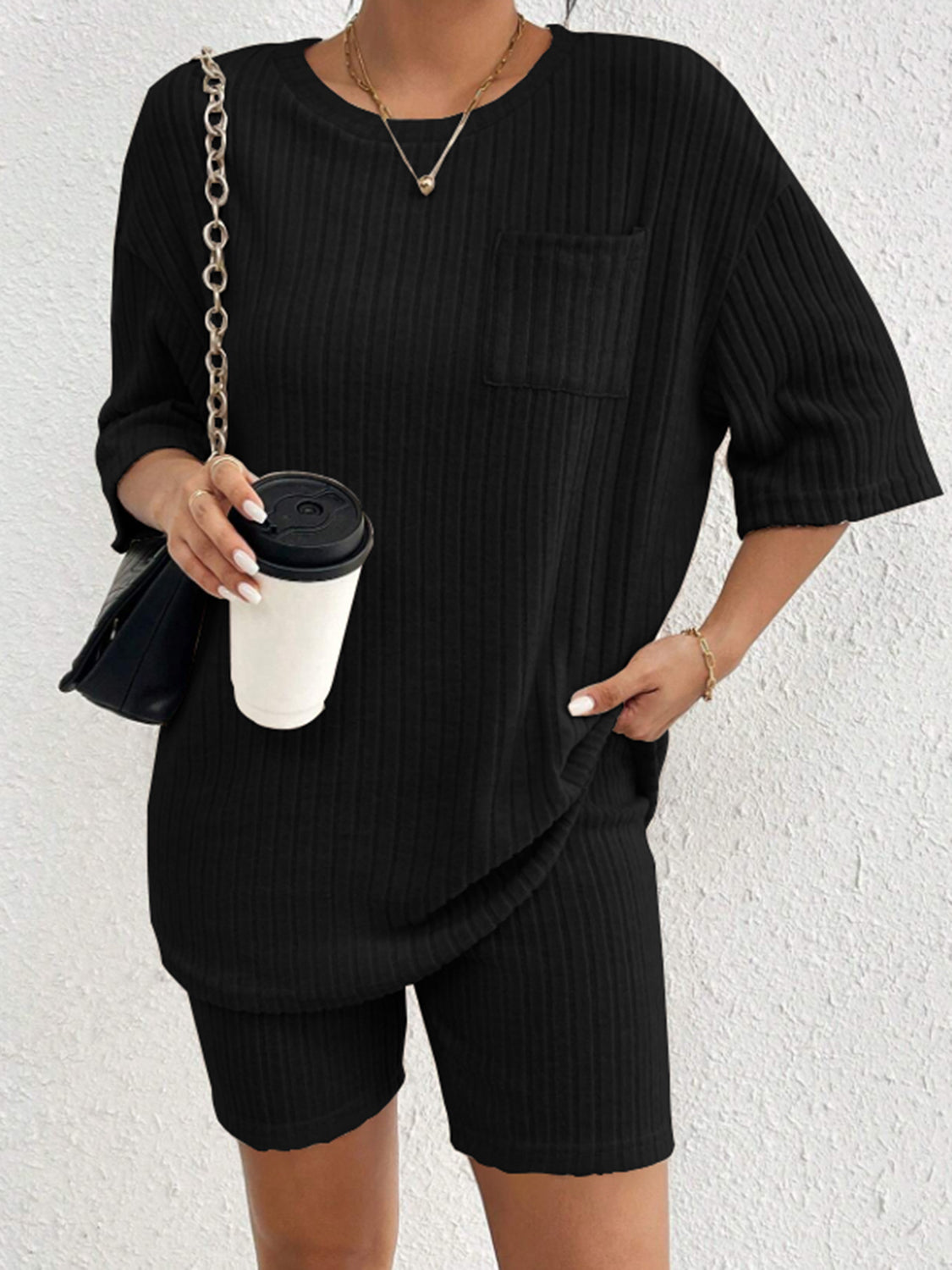 Black ribbed loungewear set with short sleeves, crew neck, and chest pocket.