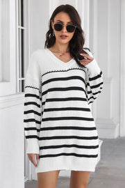 White and black striped knit mini dress with a V-neck and long sleeves.
