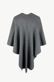Charcoal knit cape with ribbed texture and a draped silhouette.
