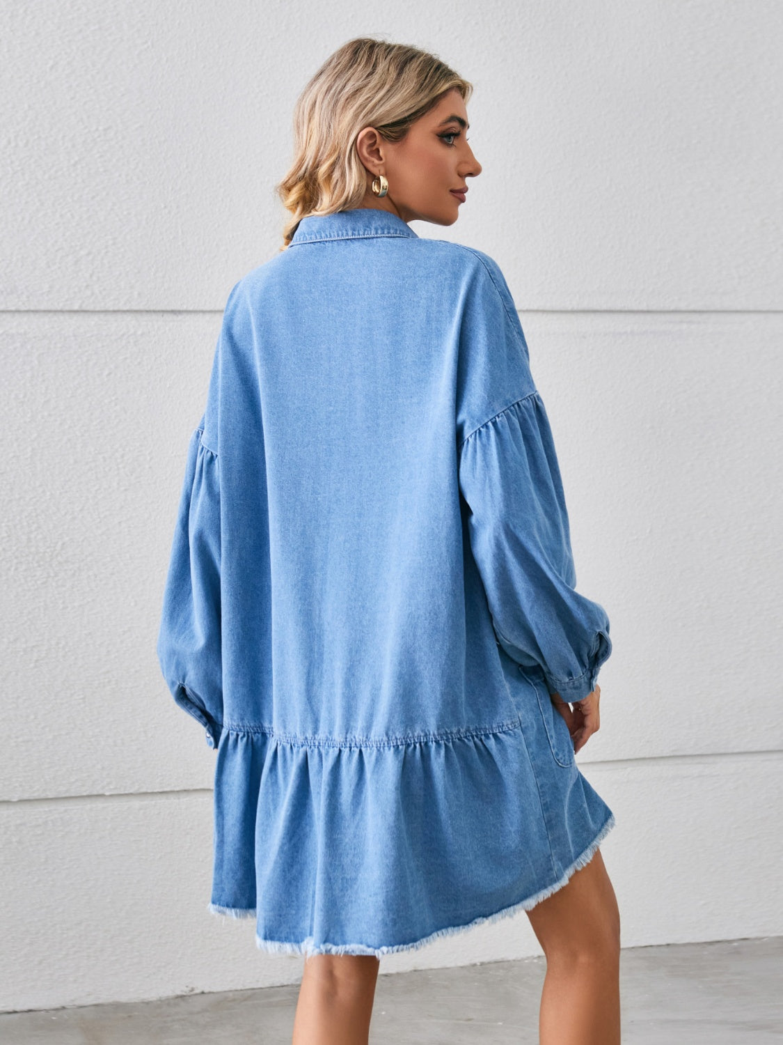 Denim shirtdress in sky blue with voluminous sleeves, tiered hem, and frayed hem.