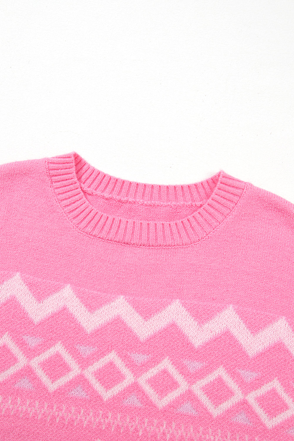 Pink acrylic knit sweater with geometric colorblock pattern and crew neck.